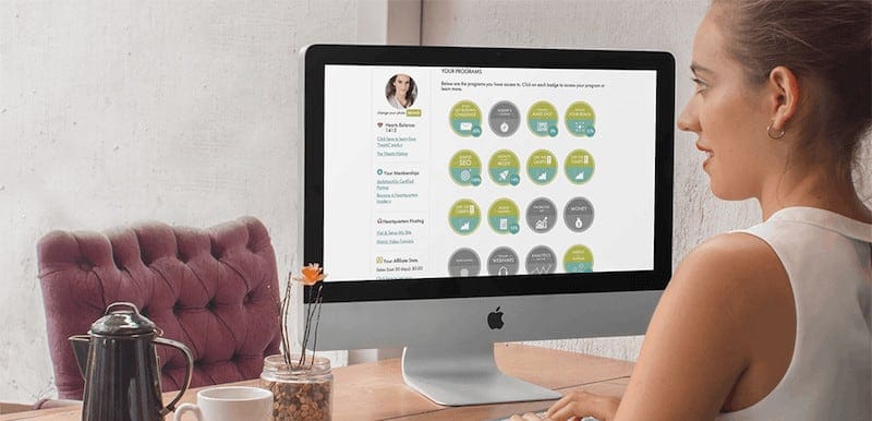 woman sitting at desk with desktop computer showcasing course dashboard
