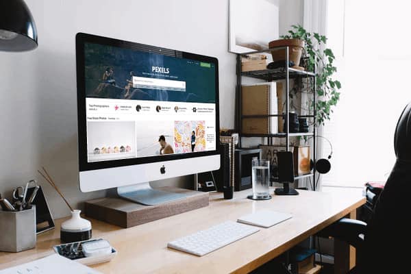 iMac on desk with example mockup of Membership site type: done for you resources.