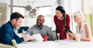 Four people looking at work documents