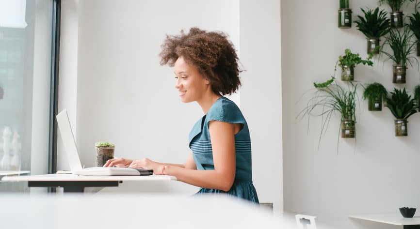 Woman sitting in front of a laptop working